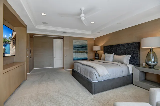 a spacious bedroom with a bed and a lamp