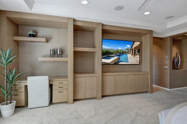 a view of kitchen with refrigerator and white cabinets