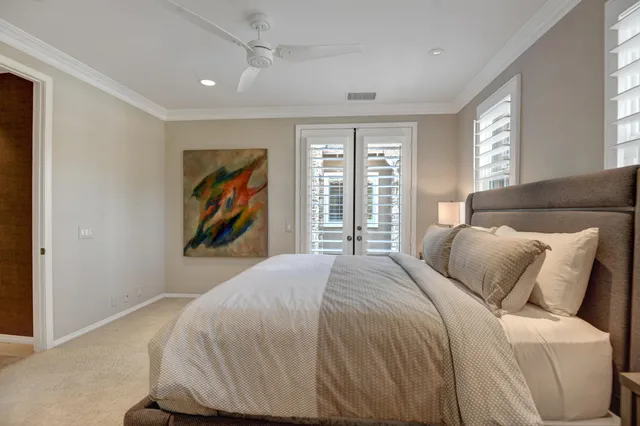 a bedroom with a bed and a painting on the wall