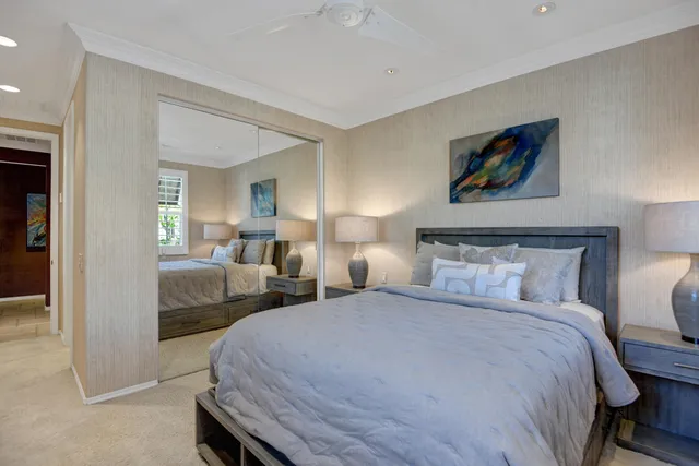 a bedroom with a bed and a large mirror