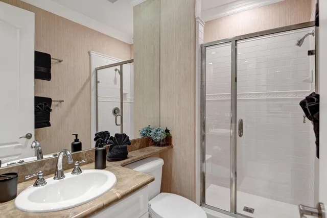 a bathroom with a sink toilet and shower