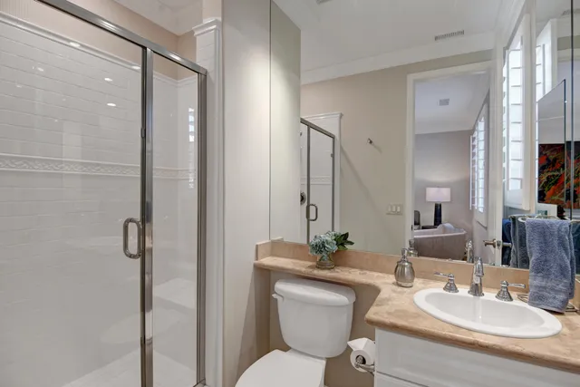 a bathroom with a toilet a sink and a mirror