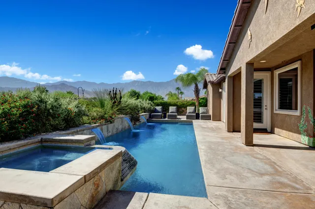 a view of a patio with swimming pool table and chairs