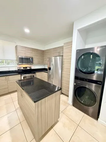 a kitchen with a sink a stove and cabinets