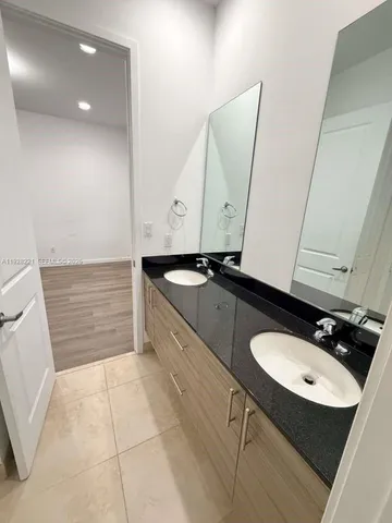 a bathroom with a sink a toilet and mirror