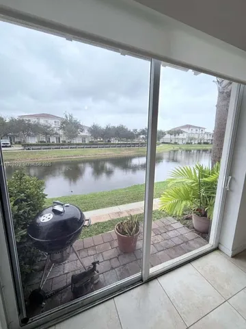 a view of a balcony with lake view and a large window