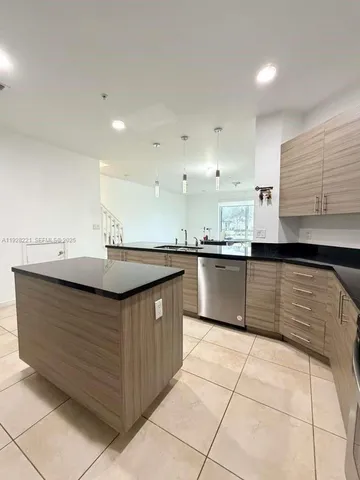 a kitchen with a sink window and cabinets