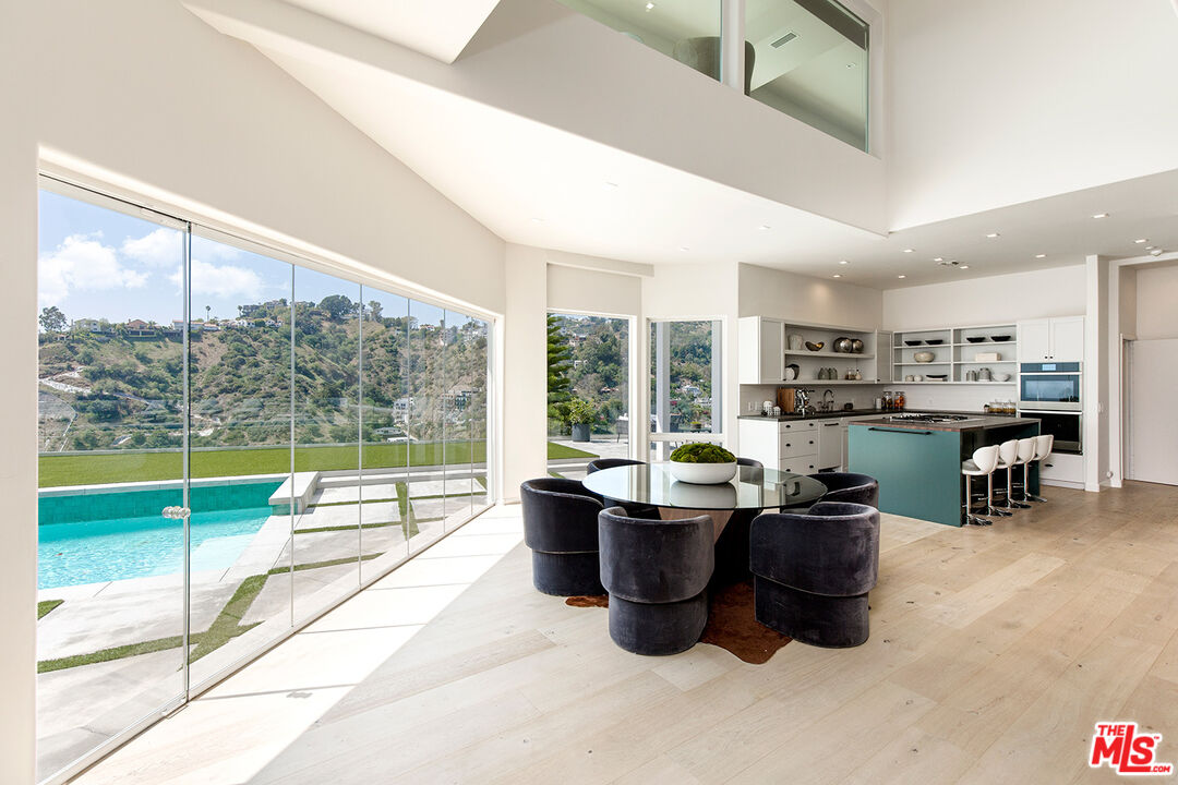 7868 Electra Drive Los Angeles, CA 90046 - Photo 12 of 38 a dining room with furniture and a floor to ceiling window