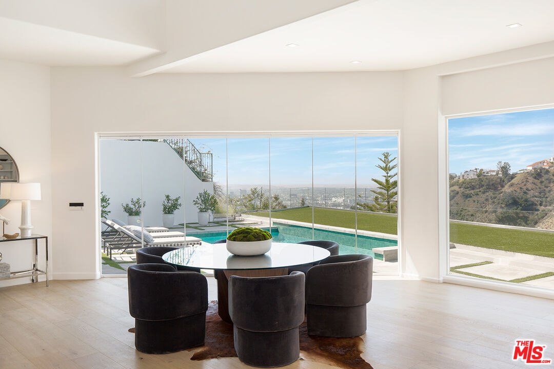 7868 Electra Drive Los Angeles, CA 90046 - Photo 13 of 38 a view of a dining room with a table and chairs