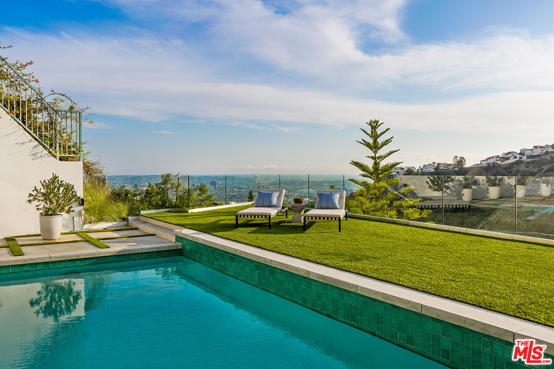 7868 Electra Drive Los Angeles, CA 90046 - Photo 15 of 38 a view of a swimming pool with lawn chairs