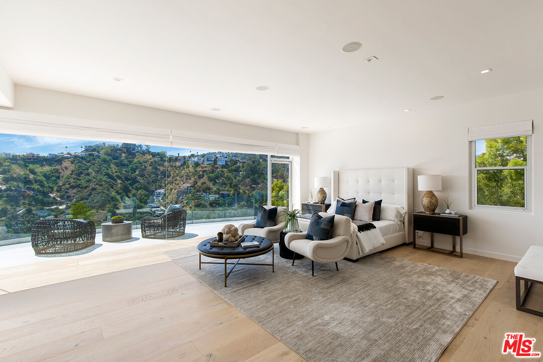 7868 Electra Drive Los Angeles, CA 90046 - Photo 25 of 38 a living room with furniture and a floor to ceiling window
