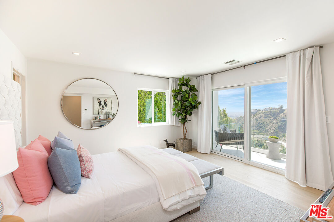 7868 Electra Drive Los Angeles, CA 90046 - Photo 34 of 38 a bedroom with a bed and a large window
