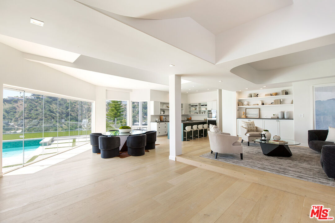 7868 Electra Drive Los Angeles, CA 90046 - Photo 10 of 38 a living room with furniture floor to ceiling window and a flat screen tv