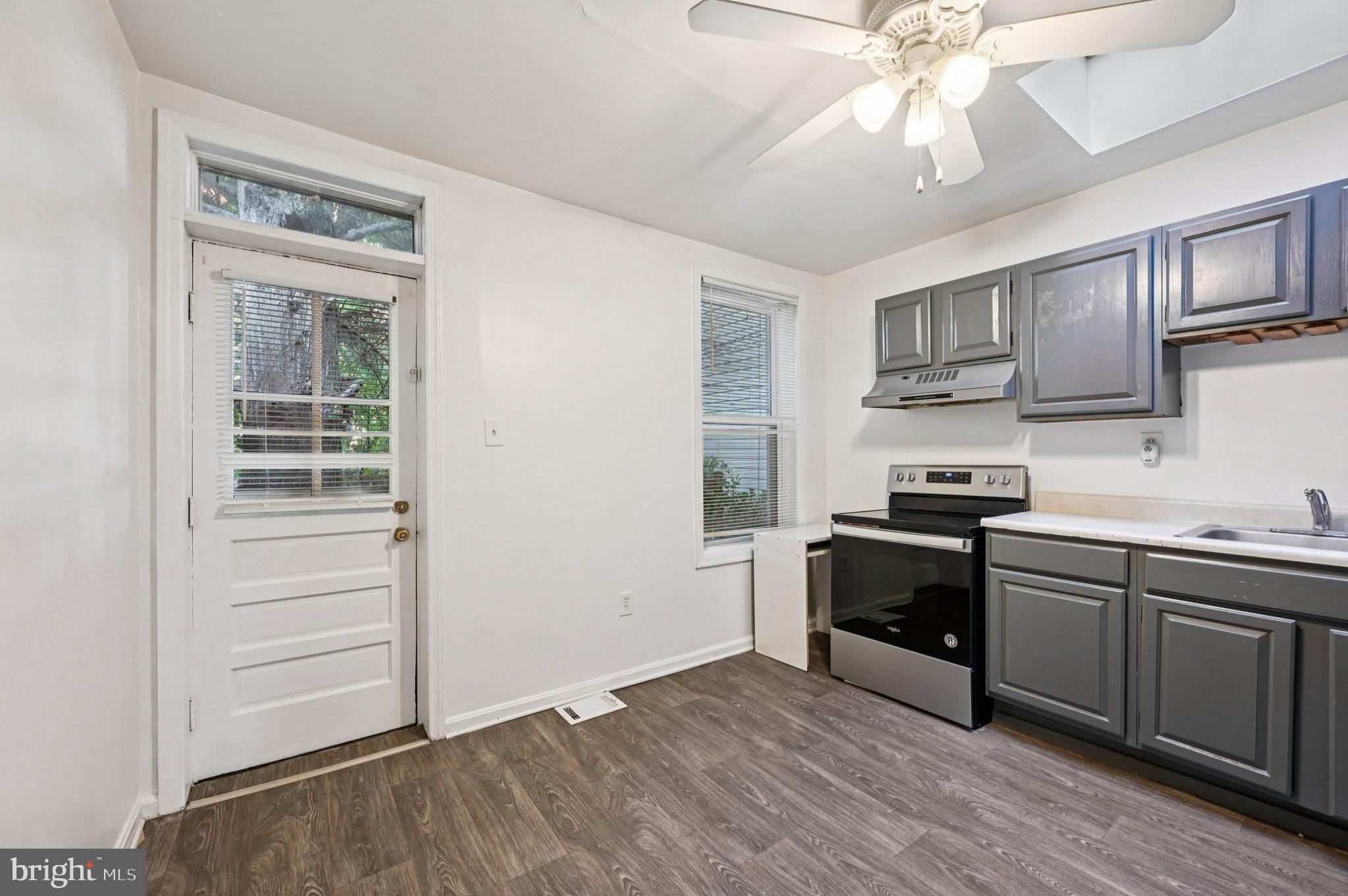 110 South Poppleton Street Baltimore, MD 21201 - Photo 12 of 39 a kitchen with stainless steel appliances a sink and a stove