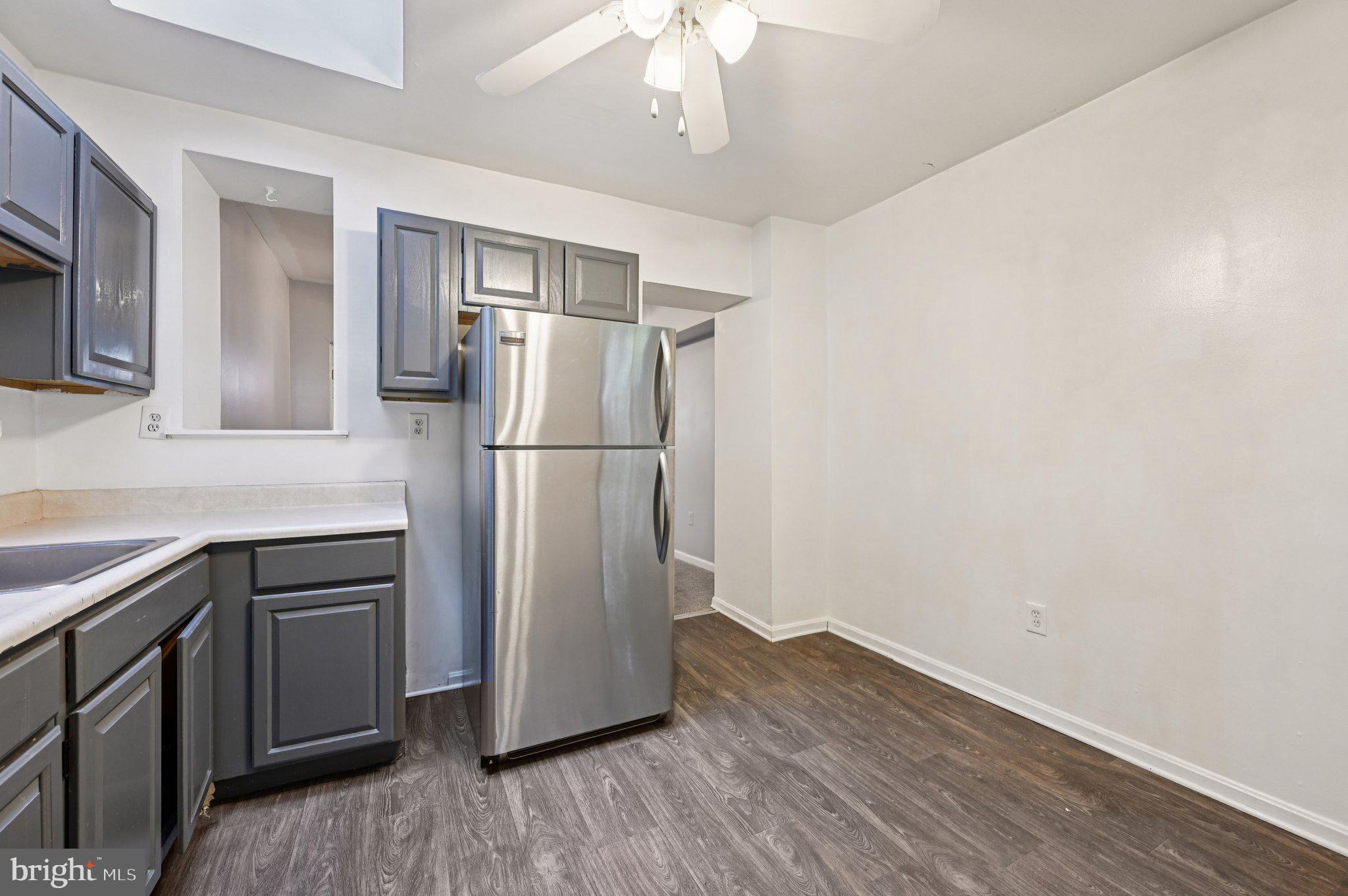 110 South Poppleton Street Baltimore, MD 21201 - Photo 13 of 39 a kitchen with a refrigerator and a sink