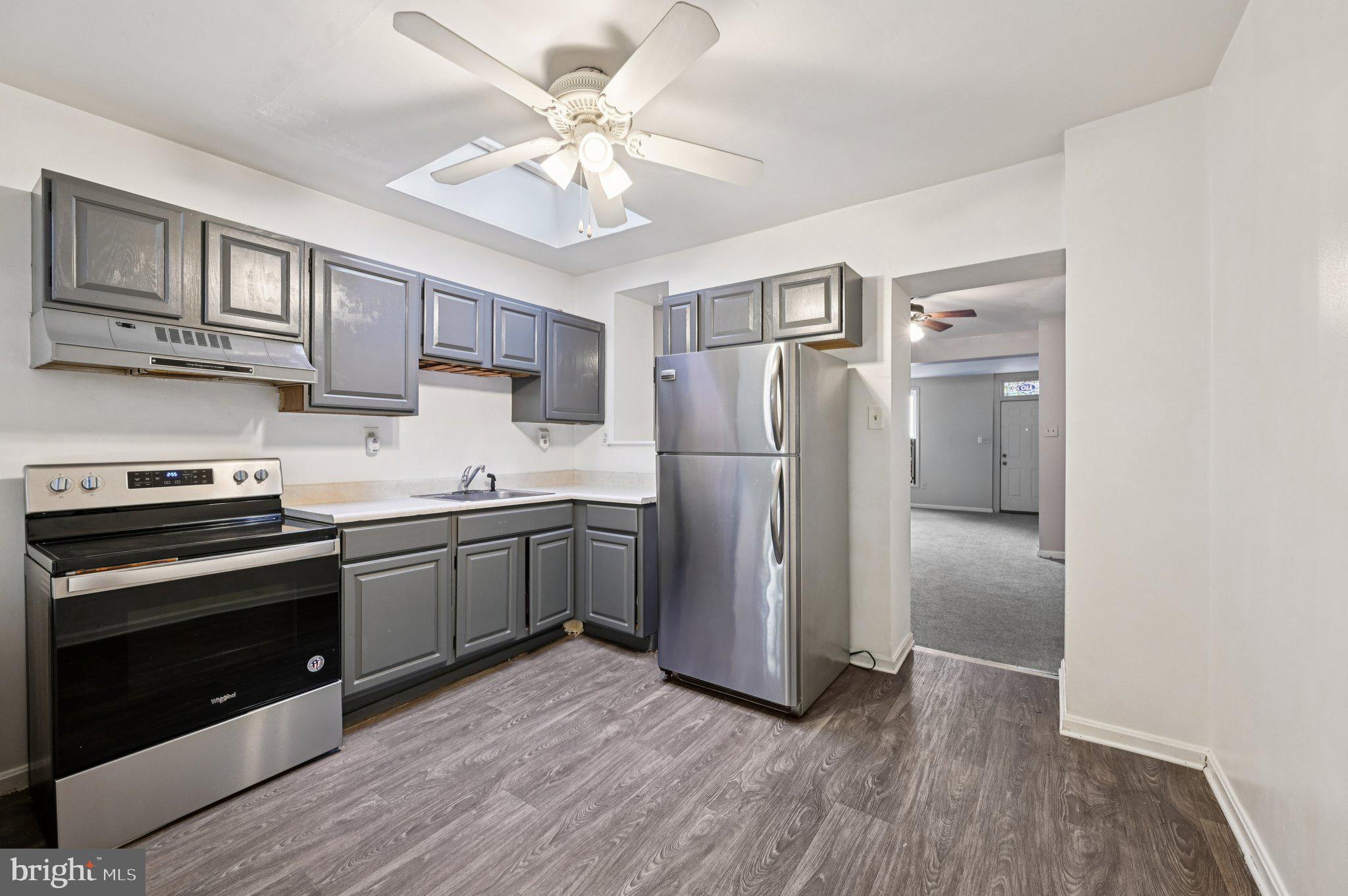 110 South Poppleton Street Baltimore, MD 21201 - Photo 14 of 39 a kitchen with stainless steel appliances granite countertop a refrigerator and a stove top oven