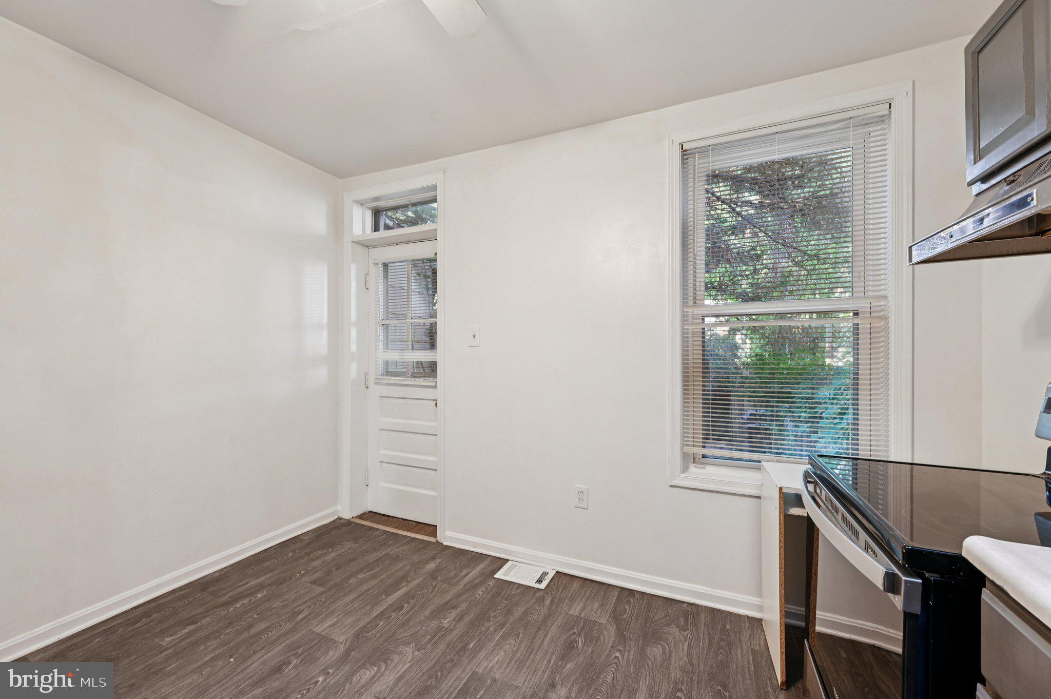 110 South Poppleton Street Baltimore, MD 21201 - Photo 15 of 39 an empty room with wooden floor and windows