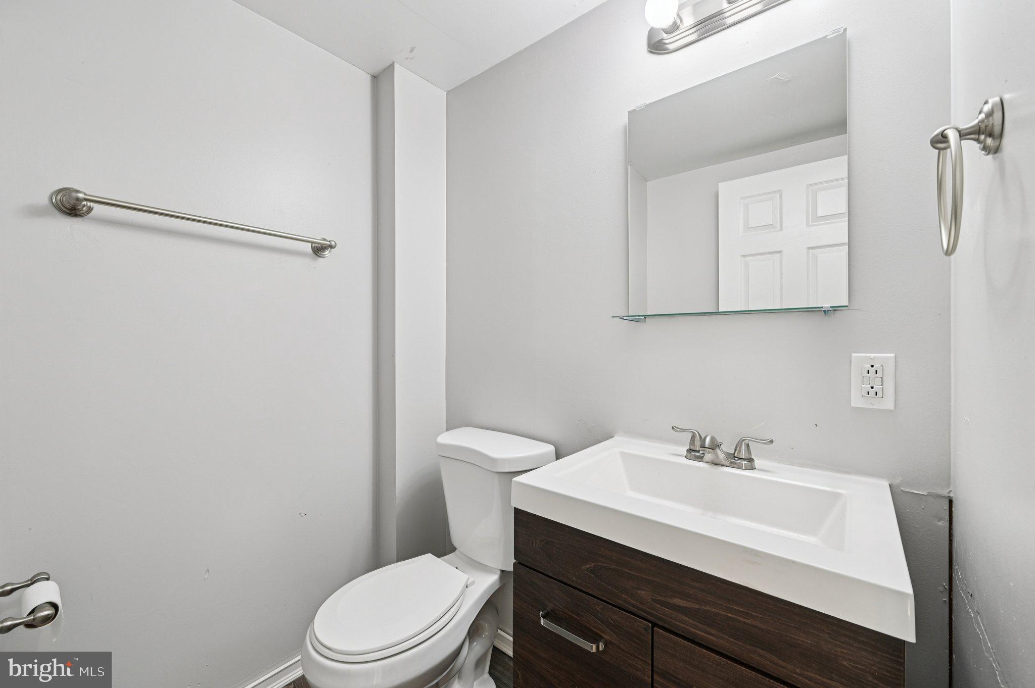 110 South Poppleton Street Baltimore, MD 21201 - Photo 22 of 39 a bathroom with a sink a toilet and mirror