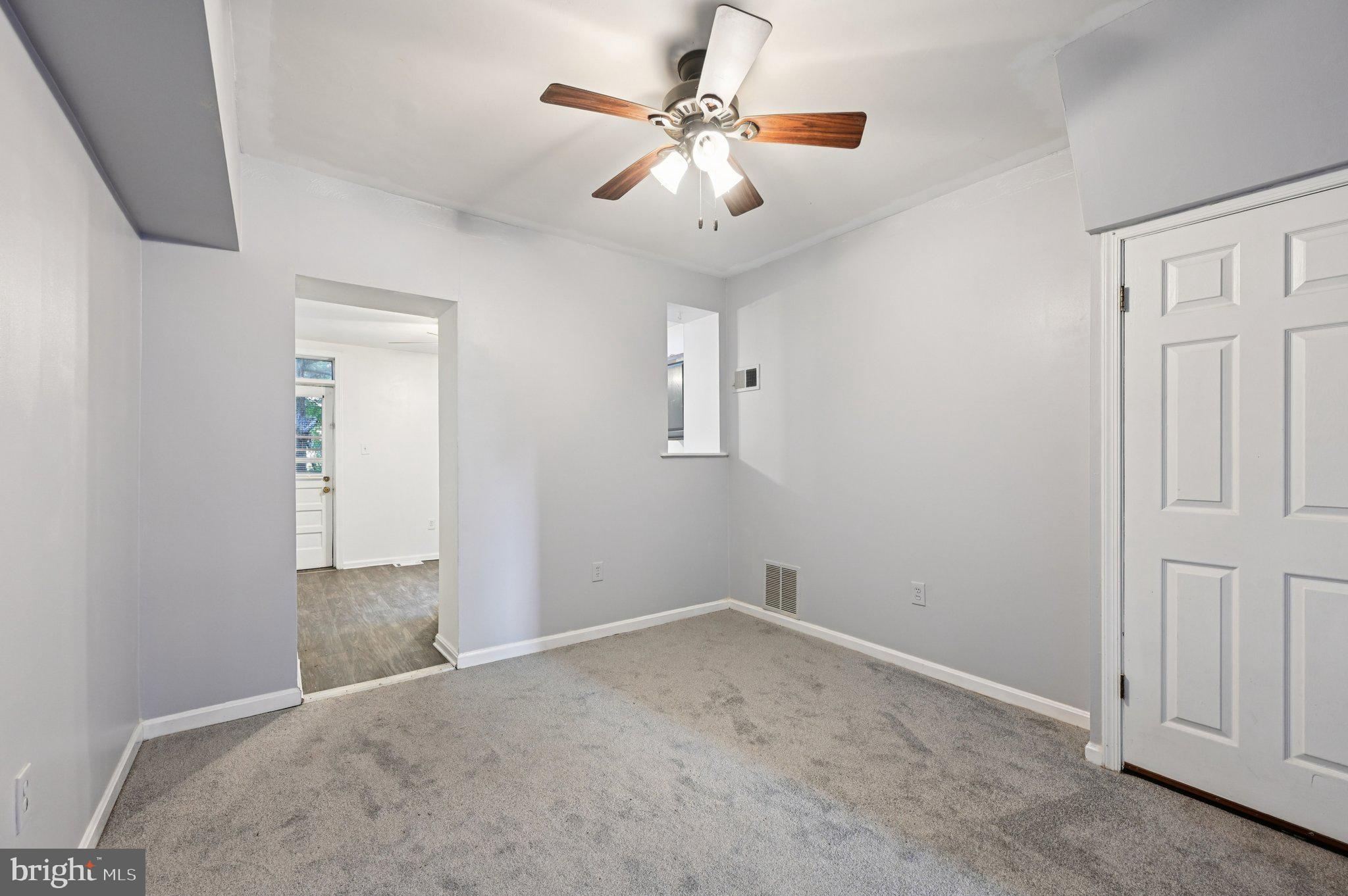 110 South Poppleton Street Baltimore, MD 21201 - Photo 8 of 39 an empty room with chandelier fan and windows