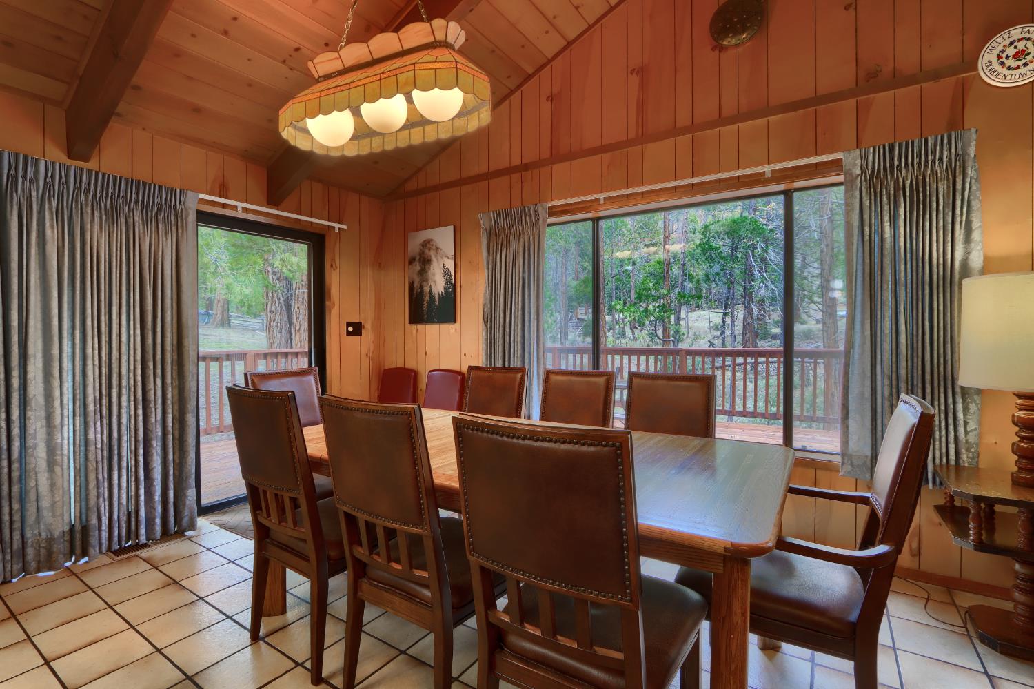 8041 Chilnualna Falls Road Wawona, CA 95389 - Photo 7 of 46 a view of a dining room with furniture large windows and wooden floor
