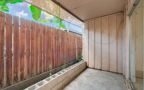 a view of a balcony with wooden fence