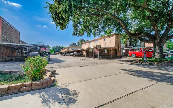 a front view of a house with a yard and trees