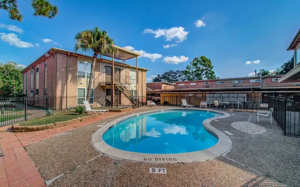 a view of a house with swimming pool and sitting area