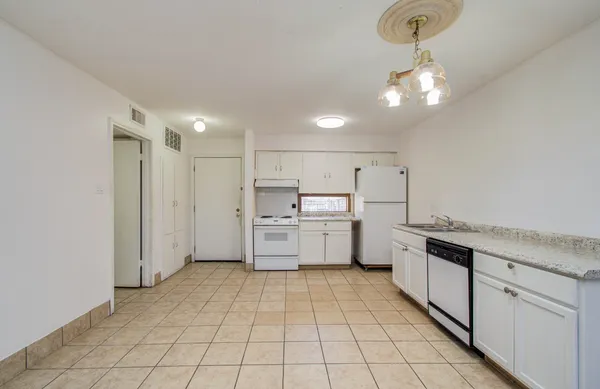 a kitchen with stainless steel appliances a sink and cabinets