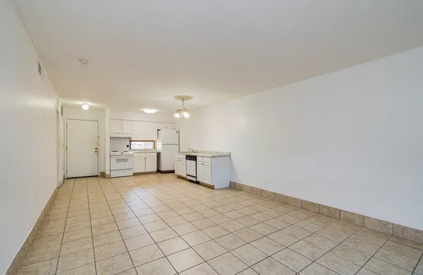 a view of a kitchen with a sink and a refrigerator