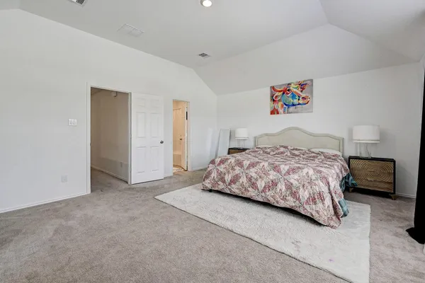 a bedroom with a bed and a couch
