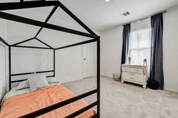 a bedroom with a bed and a dresser