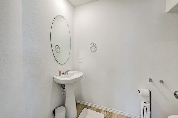 a bathroom with a sink mirror and toilet