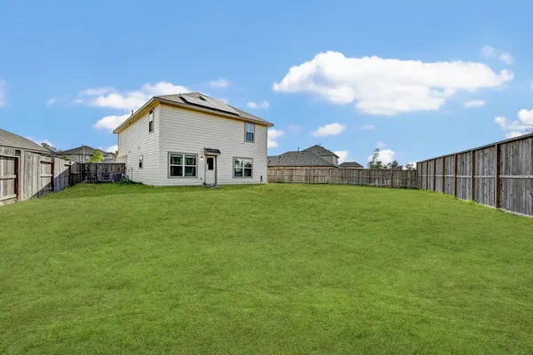 a view of a house with a yard and sitting area
