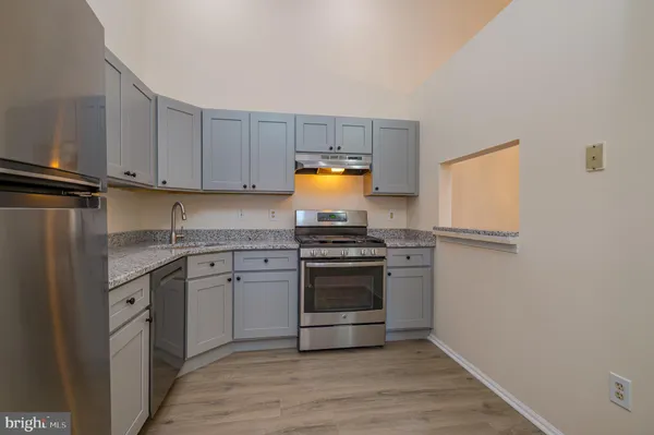 a kitchen with granite countertop a stove and a sink