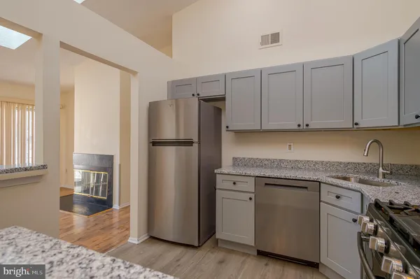 a kitchen with stainless steel appliances granite countertop a refrigerator sink and cabinets