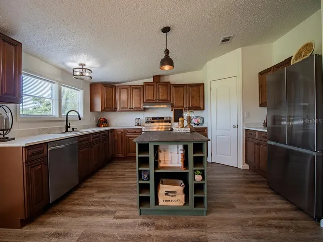 a kitchen with a table and chairs in it