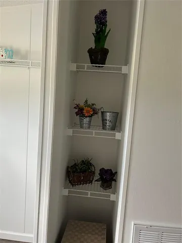 a spacious bedroom with a bed and wooden floor