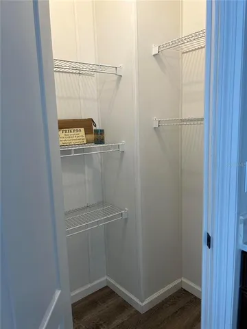 a bedroom with wooden floor and a bed