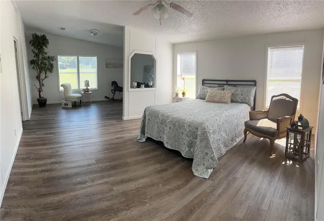 a bathroom with a double vanity sink a toilet and a large mirror