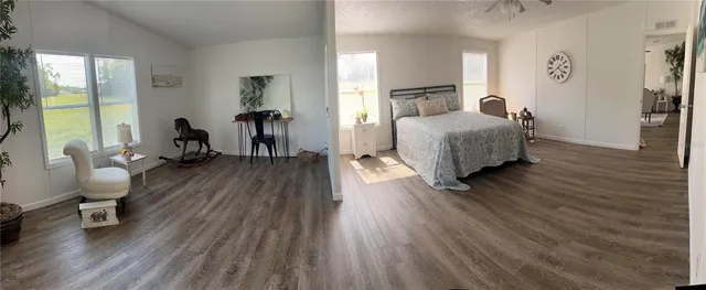 a bathroom with a granite countertop sink and a toilet