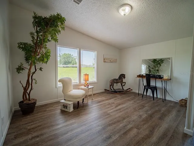 a white bath tub sitting in a bathroom next to a small yard