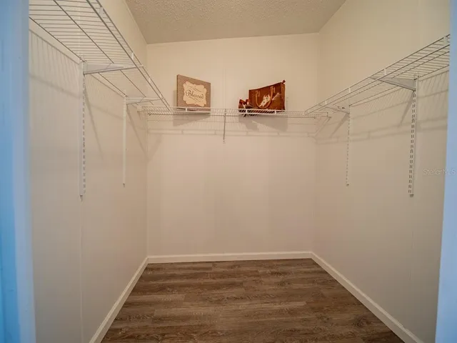 a bedroom with a bed and a lamp