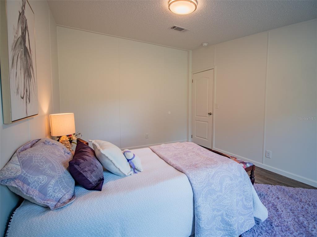 19456 161st Court O'Brien, FL 32071 - Photo 32 of 60 a bedroom with a bed and a lamp