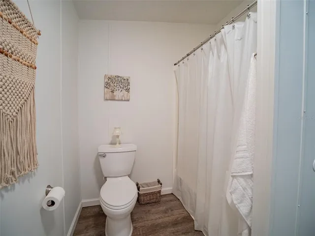 a room with a wooden floor and a window