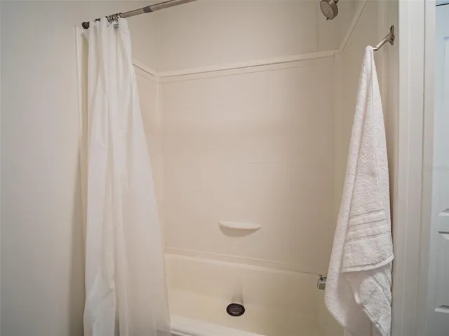 a view of a green field with wooden fence