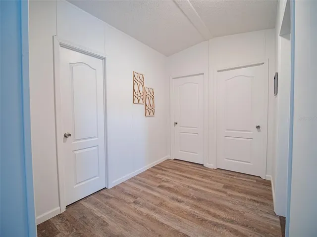 a view of a green field with wooden fence