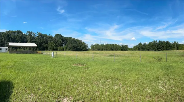 a view of a house with a big yard