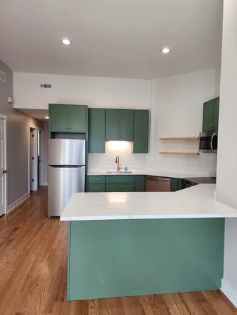 a kitchen with a refrigerator sink and cabinets