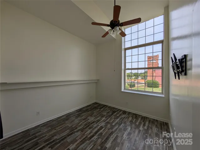a view of a room with window and a ceiling fan