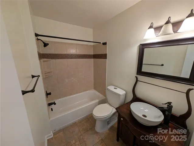 a bathroom with a toilet a sink and a shower